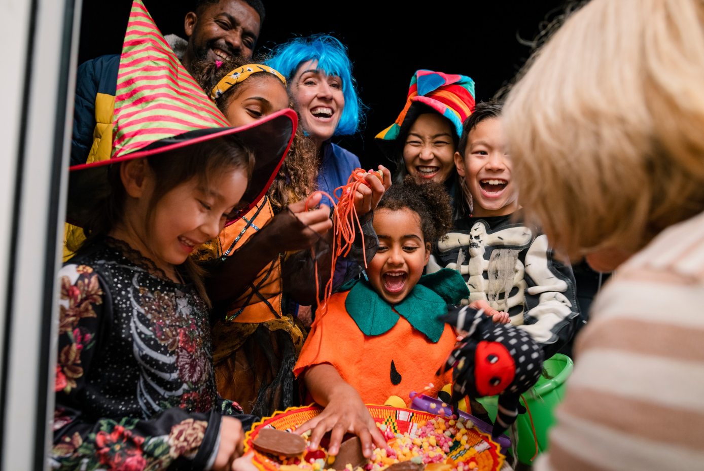 Kids in costumes collecting treats